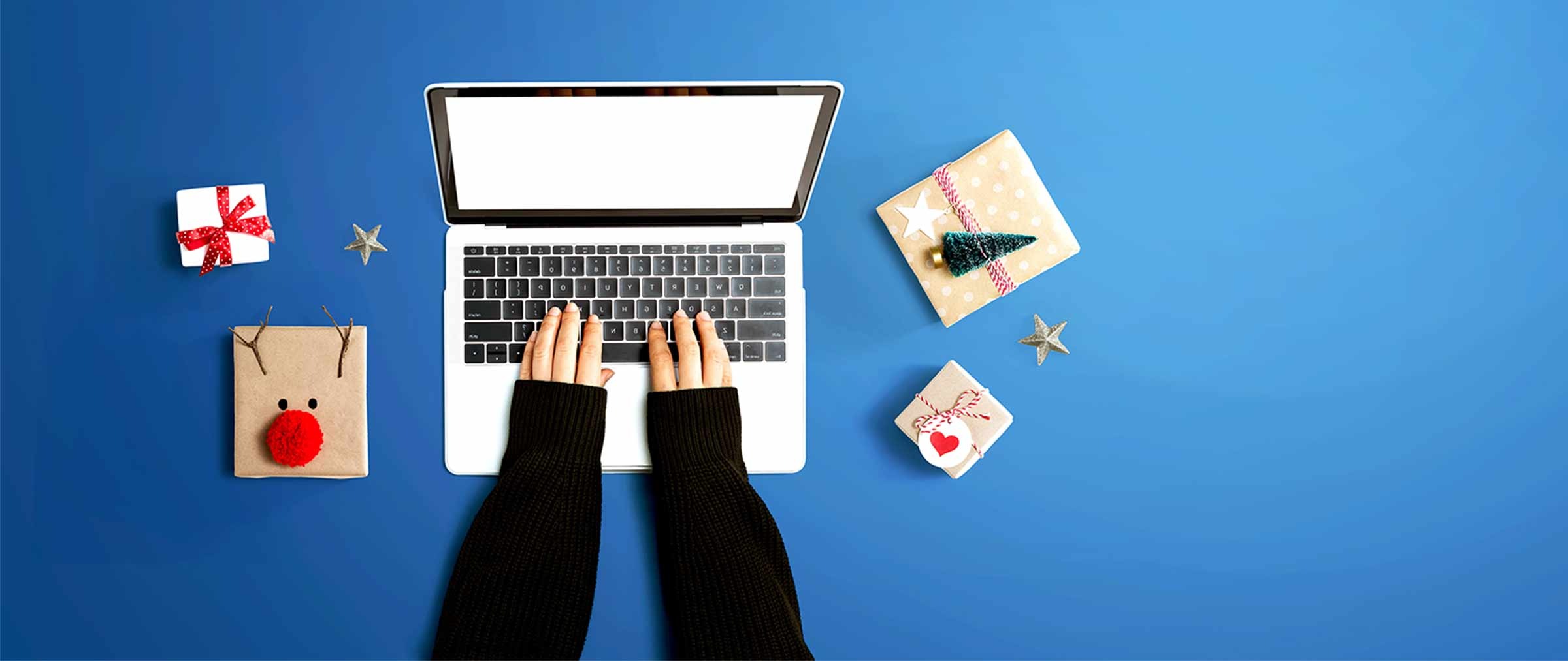 photo with blue background, computer, hands with a black sweater, gifts