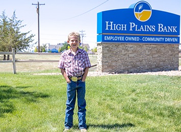 Photo of Tuff Glassmann in front of High Plains Bank sign in Bennett