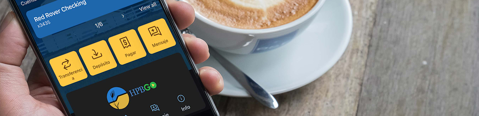 hand holding phone with cup of coffee