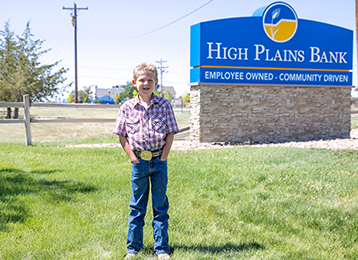 Photo of Tuff Glassmann in front of High Plains Bank sign in Bennett