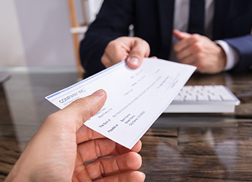 Person handing a check