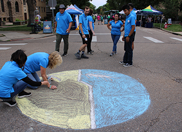photo of people drawing wheat ball chalk art