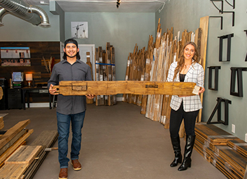 photo of authentic barnwood owners holding a piece of wood