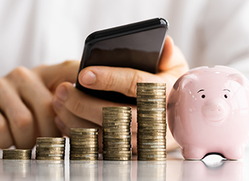 photo of piggy bank, phone, hand, coins