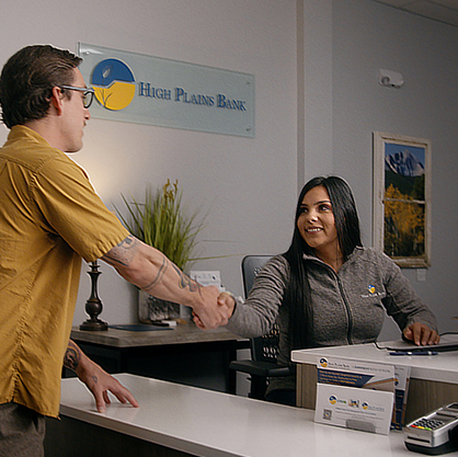 photo of customer shaking hands with customer service representative