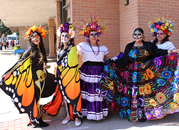 photo of four women in day of the dead costumes