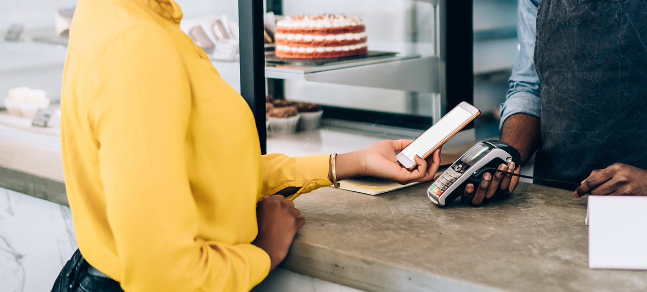 woman paying in store with mobile phone