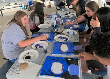 photo of young people painting