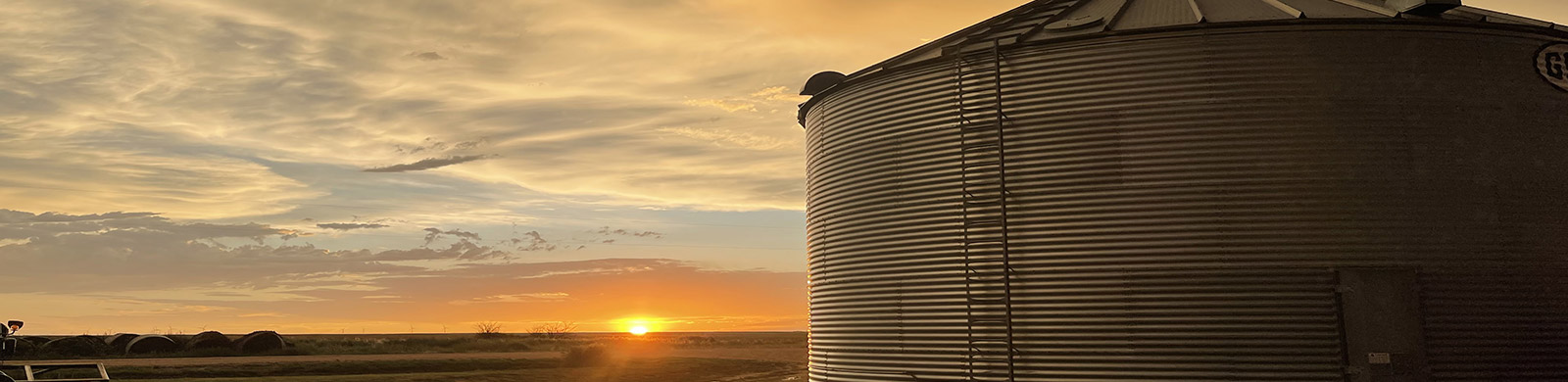 photo of sunrise with a water tower