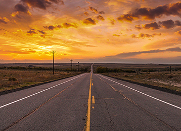 Photo of open road at sunset
