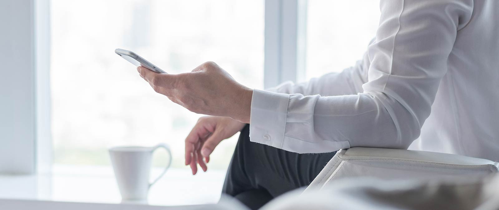 person sitting holding a phone