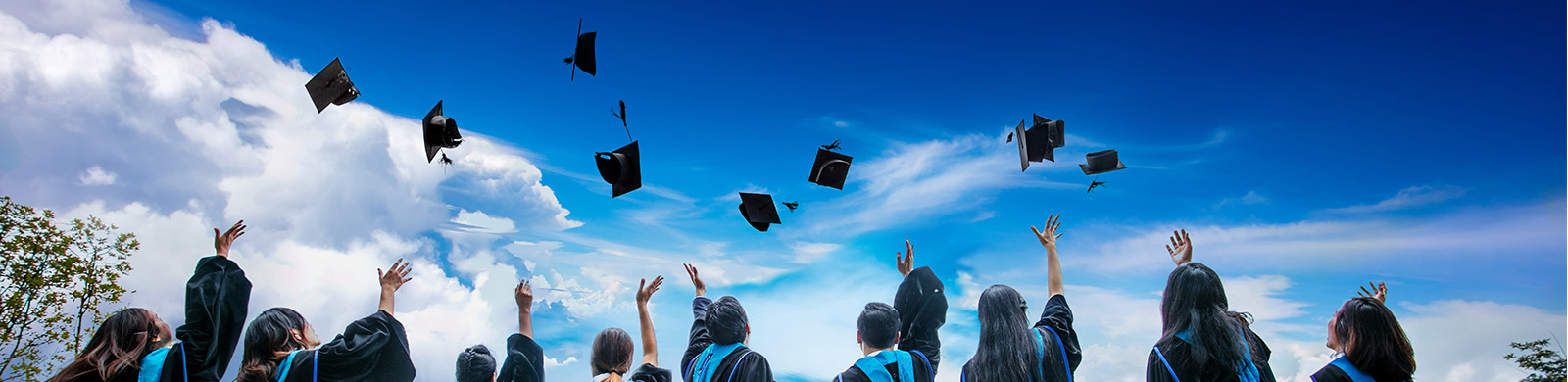 graduates tossing hats into the air 